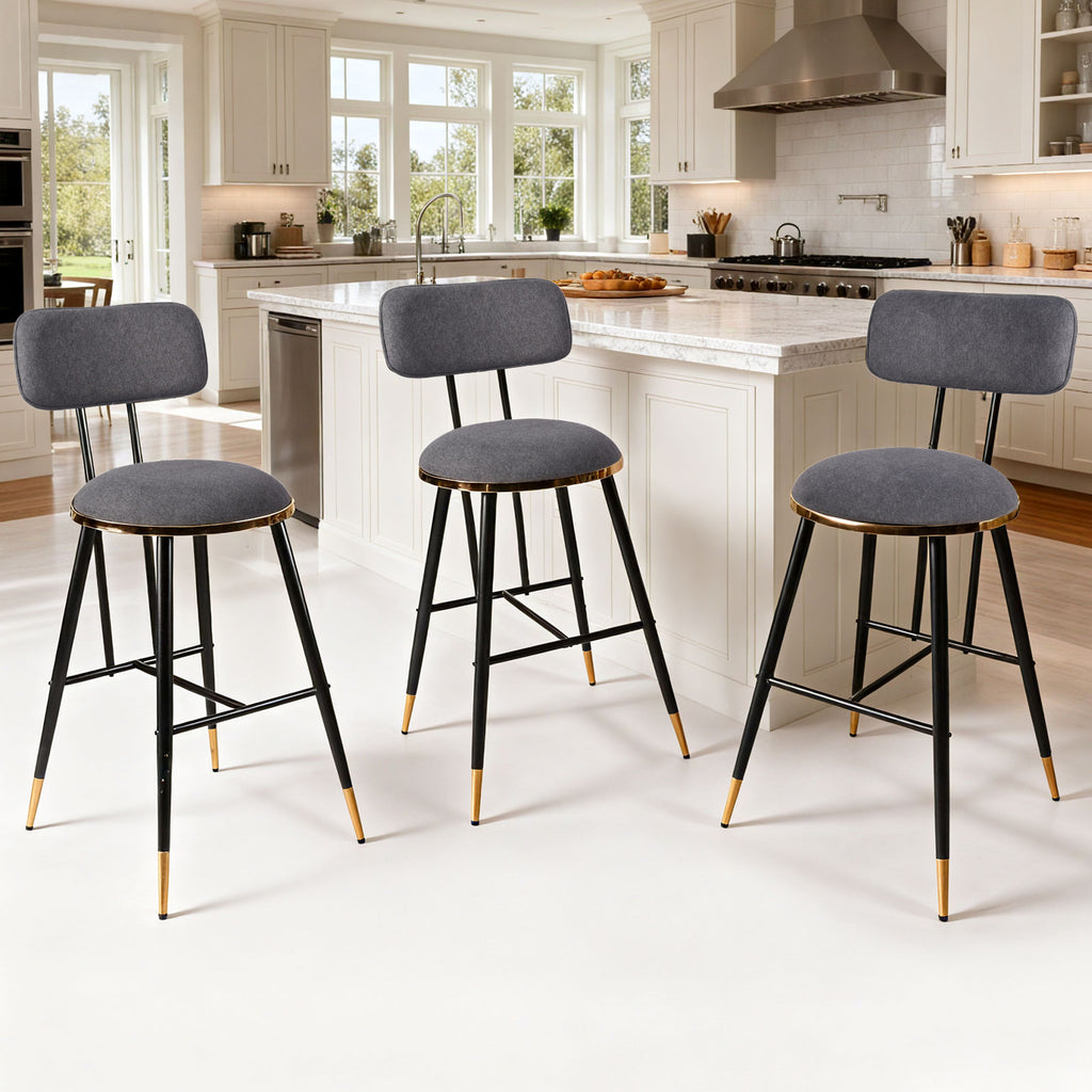 Three bar stools with gray seats and black frames in a kitchen setting