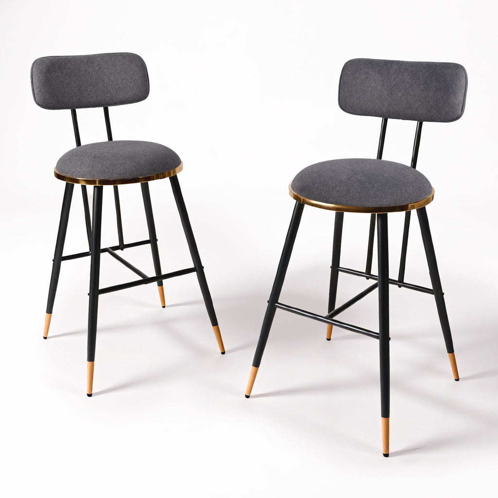 Two bar stools with gray seats and black frames on a white background