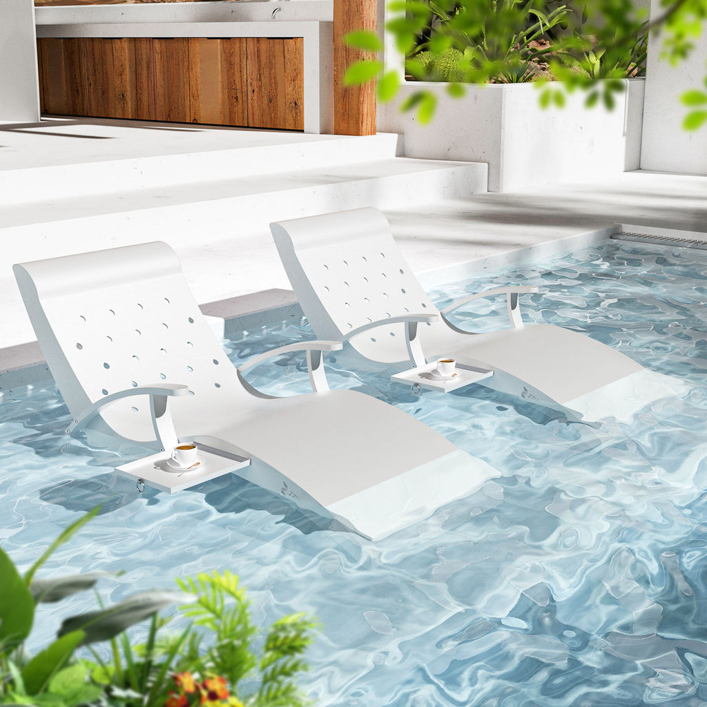 White lounge chairs on a pool deck with a scenic view